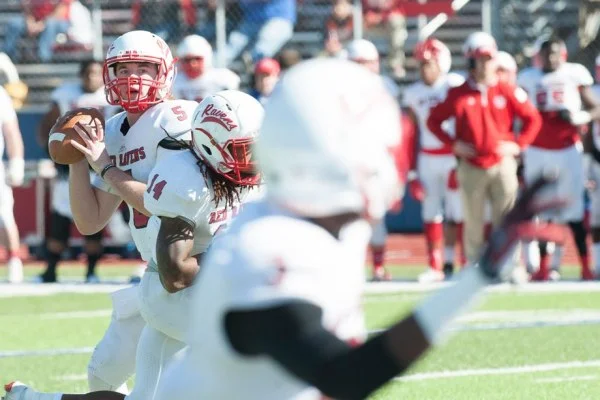 American football quarterback throwing pass